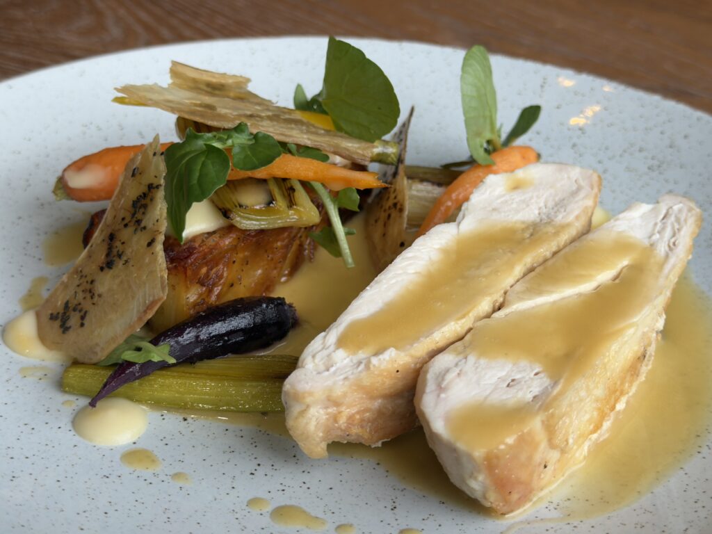 Pan roasted chicken breast with a cramy wild mushroom sauce. Served alongside fondant potato& tender stem broccoli, served at Riva Hale Restaurant.