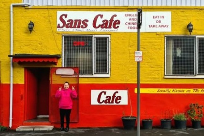 The basic red and yellow exterior of Sans Cafe in Liverpool