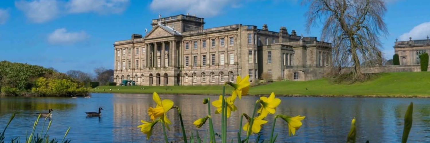 Daffodils, the lake and the house at Lyme Park