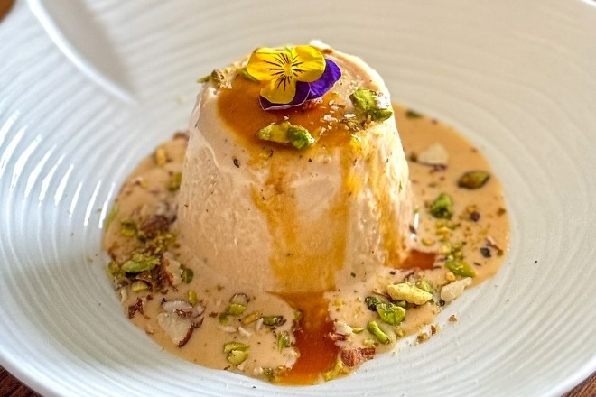 Kulfi garnished with pistachio and flowers at Prashad