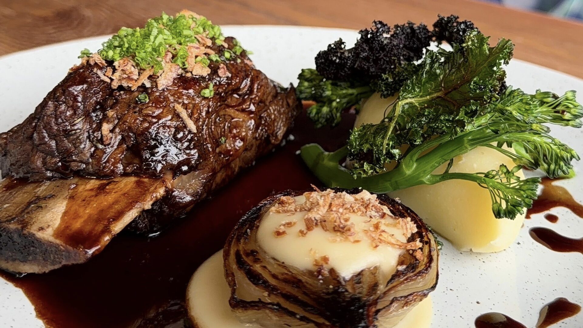 Lamb Shank on the bone served with creamy mash, tenderstem broccoli. fried shallot with a homemade meat stock gravy sauce