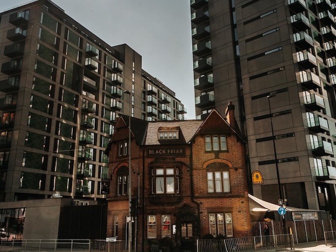 The Black Friar pub in Salford in the shadow of high-rise apartments.