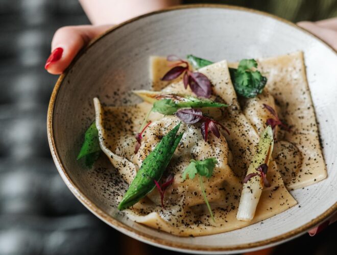 Caramelised onion and spinach raviolo with toasted pine nuts, burnt leek and lemon gel at The Black Friar in Manchester.