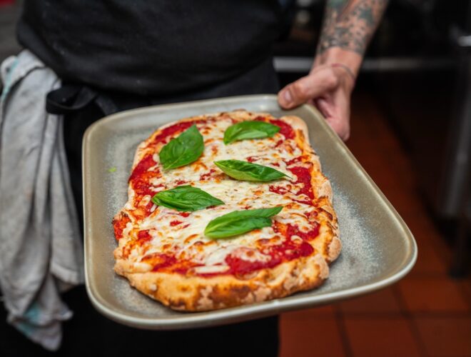 Rustic margherita pizza with basil leaves served at La Famiglia in Liverpool.