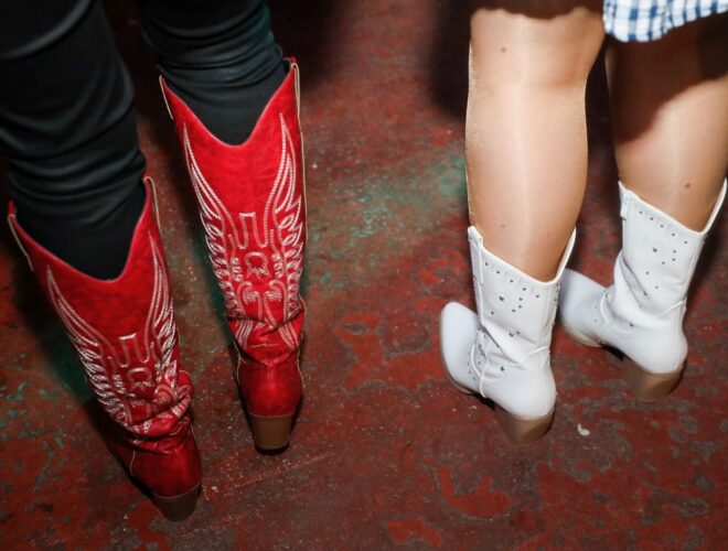 Two girls wearing cowboy boots.