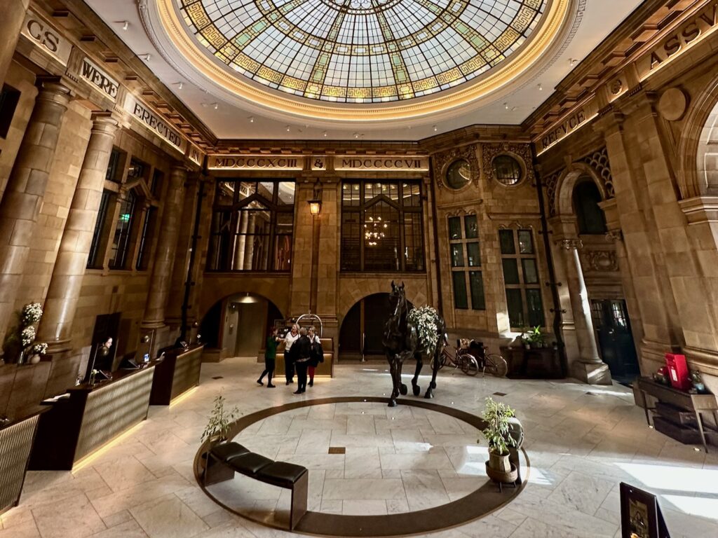 The lobby with horse sculpture and glass dome at the Kimpton Clocktower Hotel.