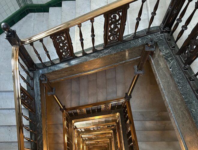 Looking down the grand staircase at The Kimpton Clocktower Hotel.