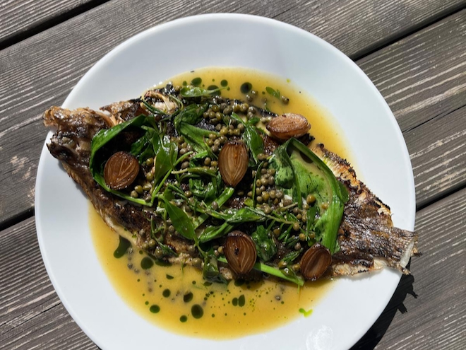 BBQ Cornish lemon sole, brown butter dashi, wild garlic, pickled onion and pine oil served at Another Hand in Manchester.