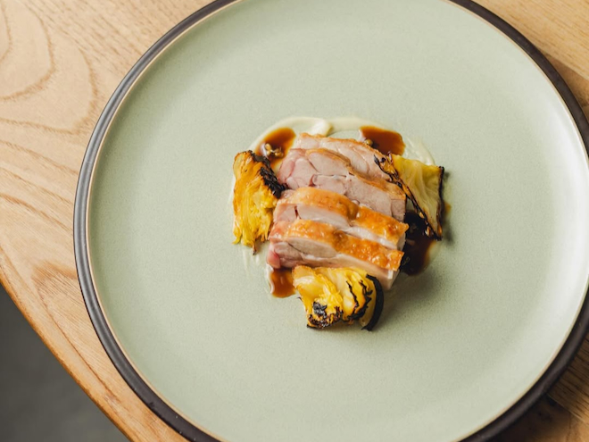 BBQ chicken served with charred cabbage at Higher Ground in Manchester.