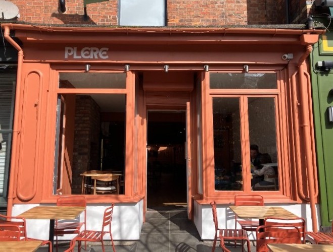 The outside of Plere with its tables in the sun