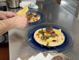 Adding parmesan tuile to the finished risotto