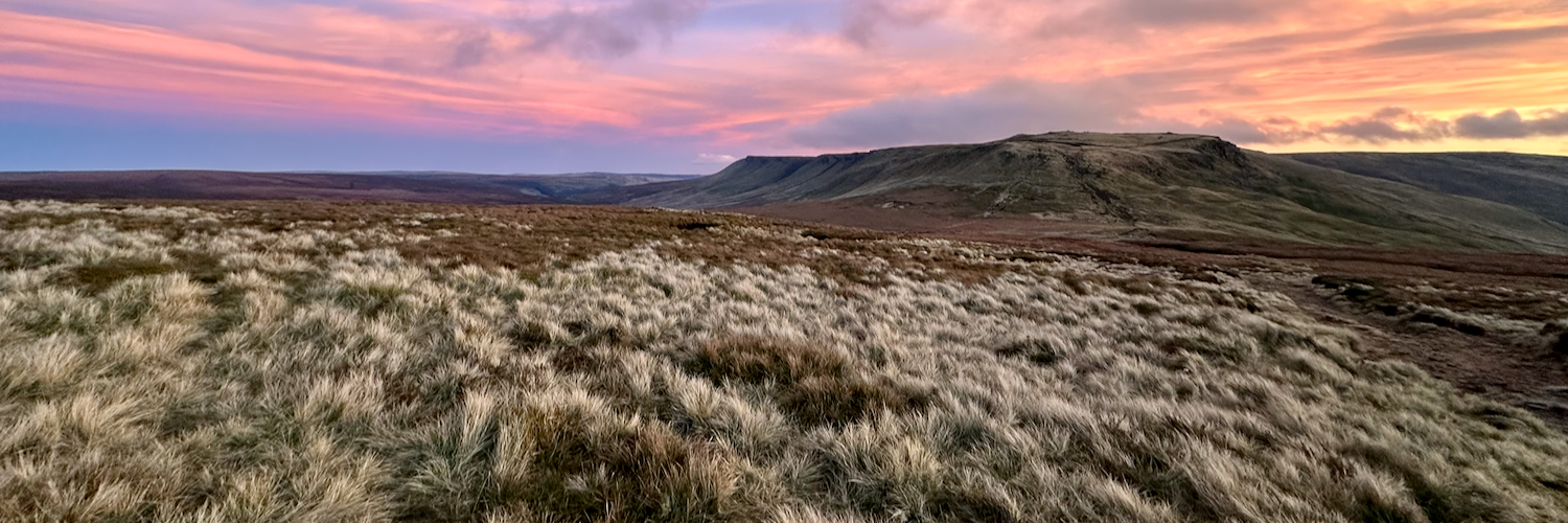 Looking towards Kinder Scout from Mill Hill in the Peak District at sunset.