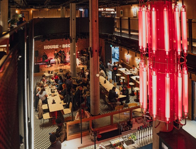 Aerial shot of ground floor tables at House of Social with band on stage and busy atmosphere