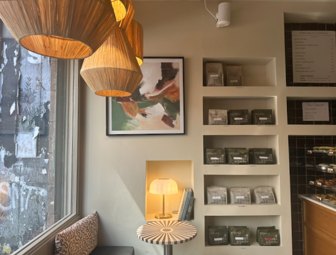 A table and shelves of bagged coffee inside Mouro, a coffee shop in the Northern Quarter, Manchester.