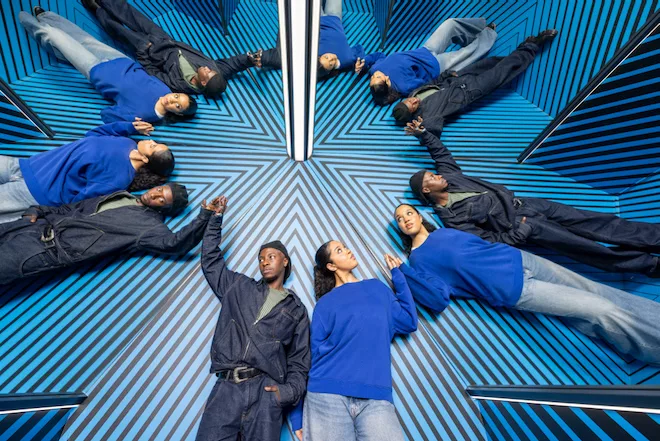 Two young people lying down in an optical illusions at Museum of Illusions Manchester.