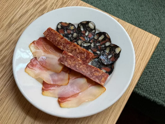 Charcuterie at Erst in Manchester: a traditional Lomo, Cacciatore with black pepper and caraway, and a pork cuttlefish ink salami with dried lime and tomato.