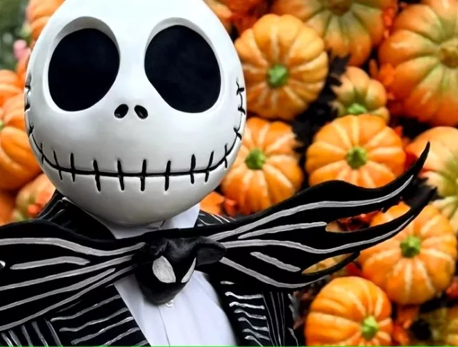 Jack Skellington in front of a wall of pumpkins