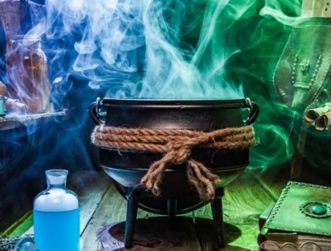 A cauldron with coloured steam rising from it